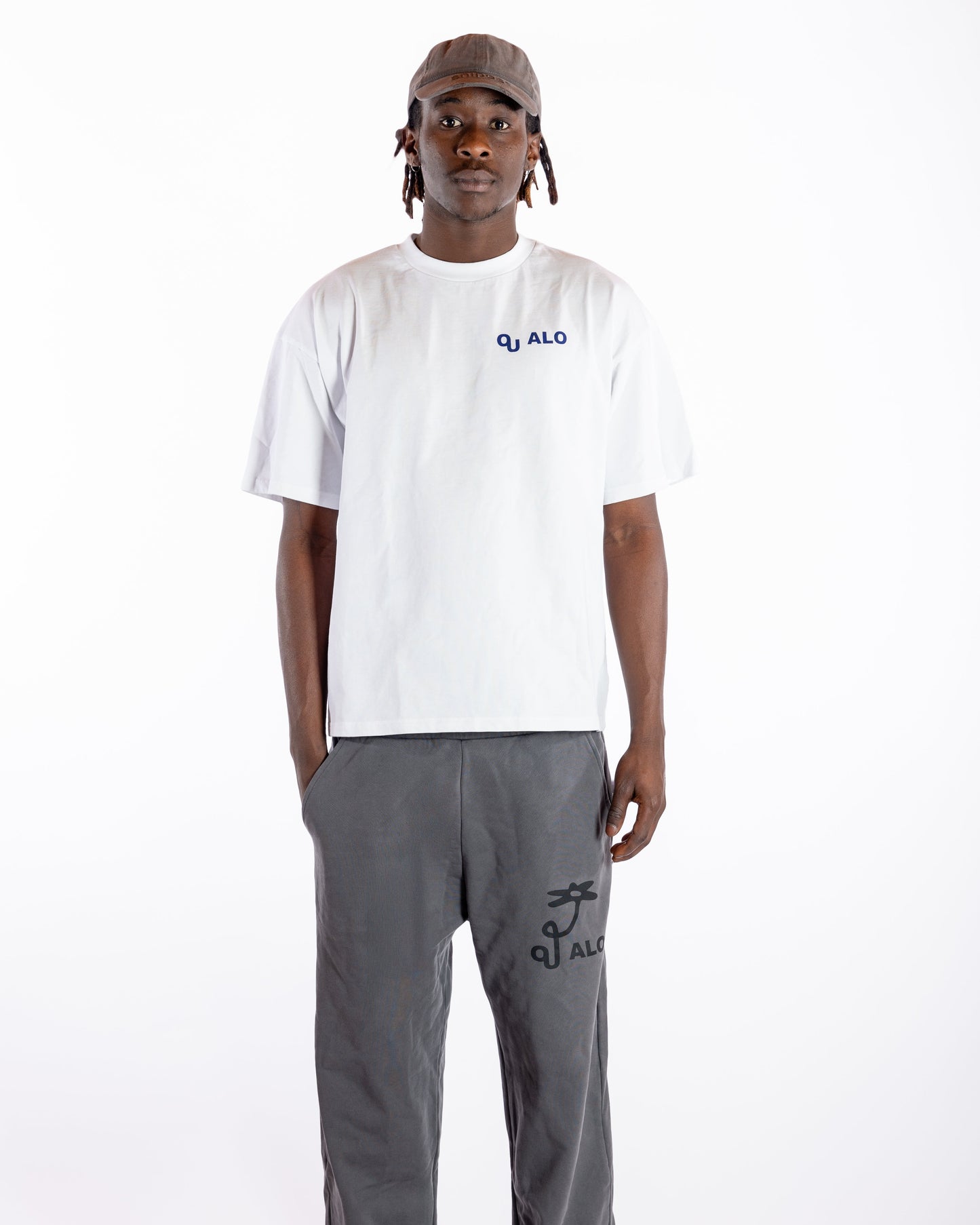 Person wearing a white t-shirt and gray pants on a white background